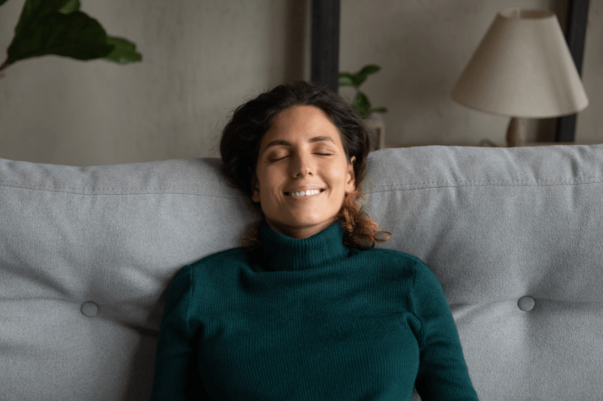 Lady smiling and relaxing on sofa