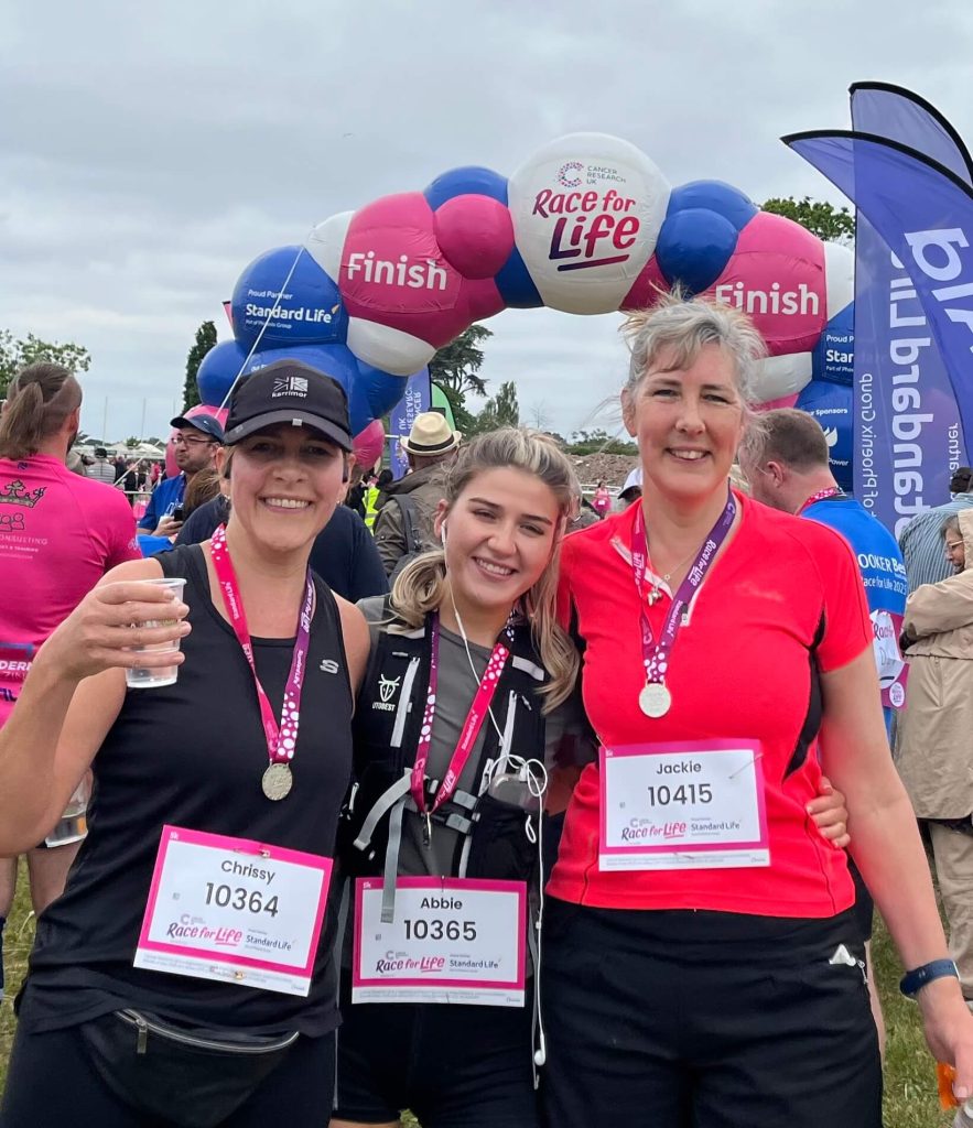 Jackie Slora with her her twin sister and niece running Race for Life.