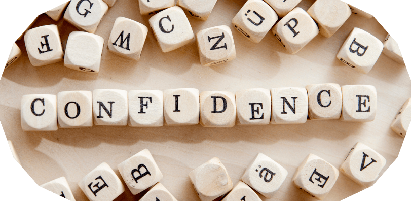 Scrabble tiles spelling the word confidence, symbolising communication skills and building confidence in workplace conversations about cancer.