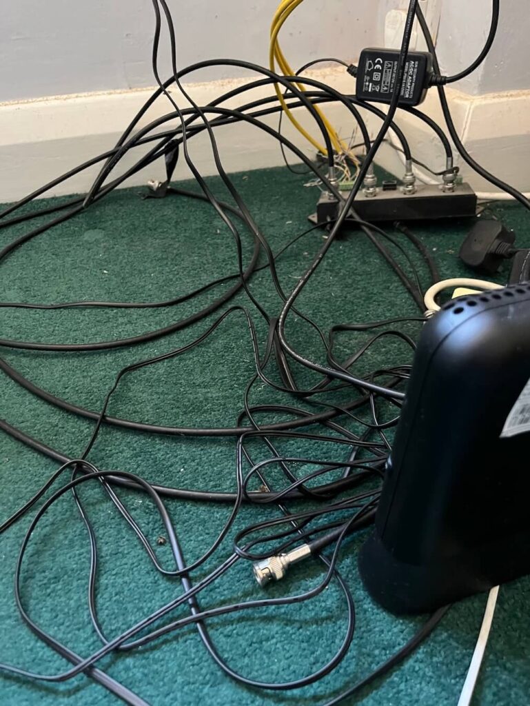 Technology cables and laptop wires causing disruption during an online hypnosis session