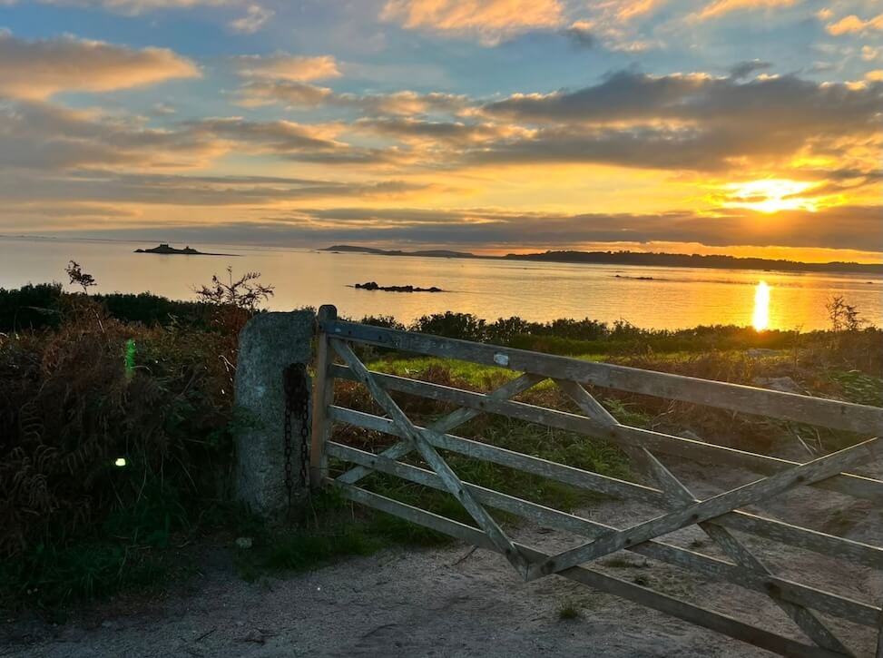 Sunset with a gate representing the onward journet